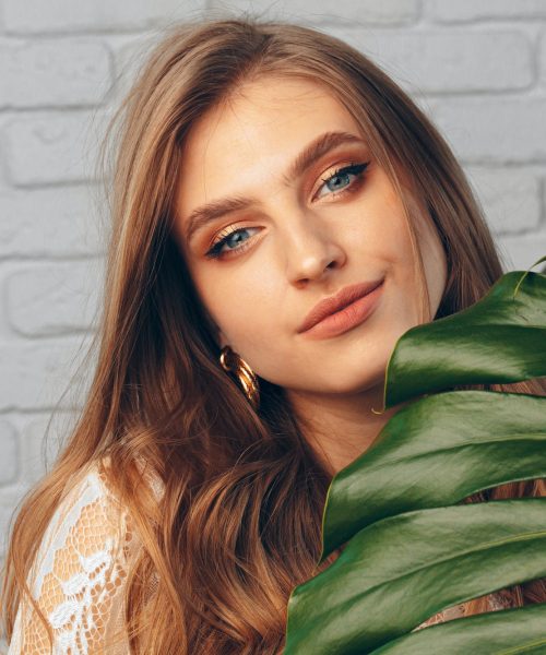 portrait-of-a-beautiful-woman-with-monstera-leaves.jpg